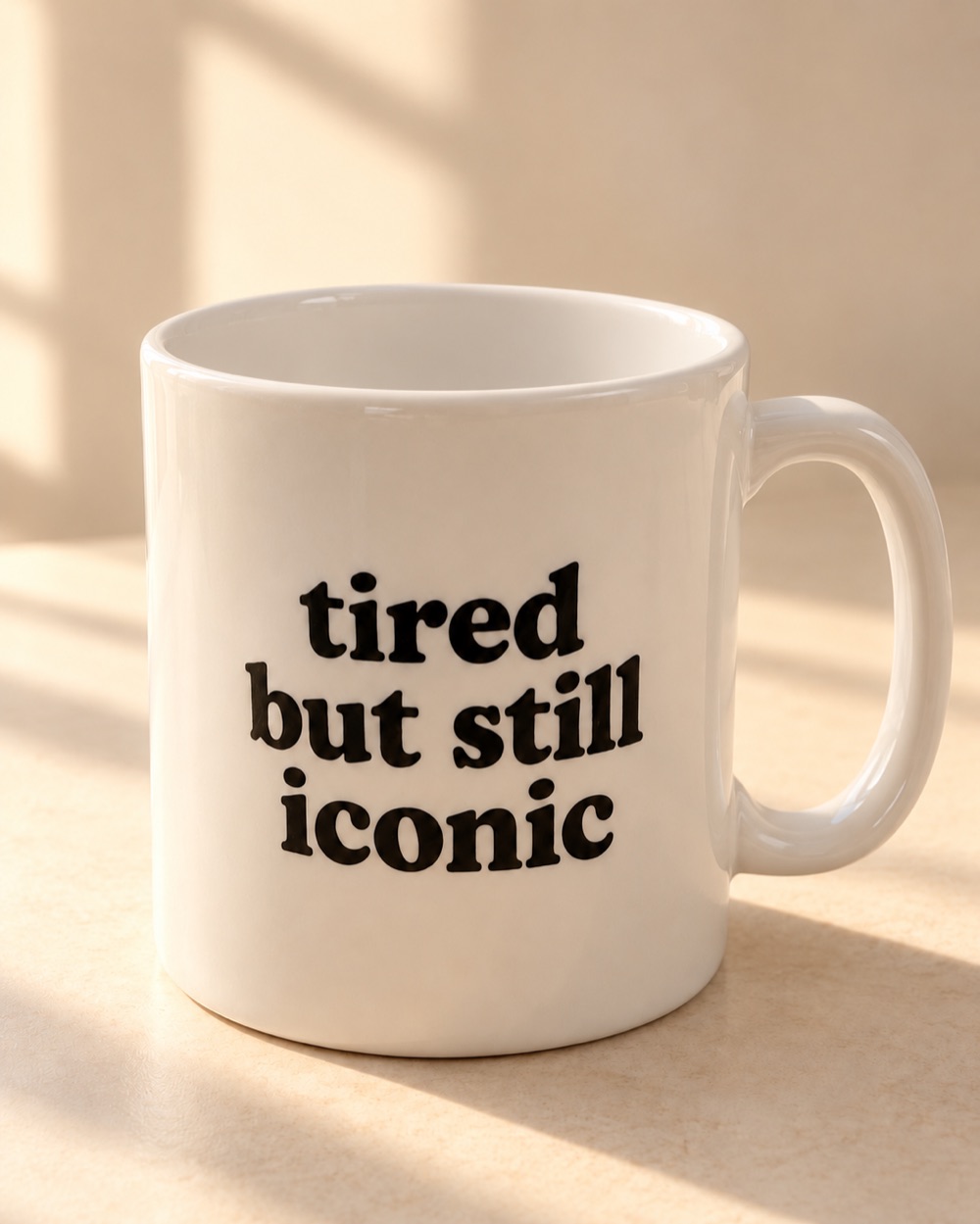 The white 11 oz mug with bold black lettering: tired but still iconic